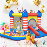 Children in casual summer outfits playing on a colorful inflatable bounce house and ball pit
