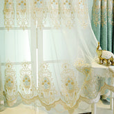 Sheer white lace curtain with gold floral embroidery and scalloped edges, elegant decor style