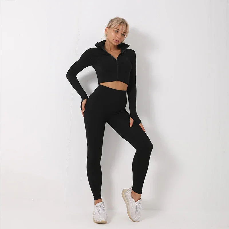 Woman wearing black long-sleeve zip-up crop top and high-waisted fitted leggings