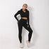 Woman wearing black long-sleeve zip-up crop top and high-waisted fitted leggings