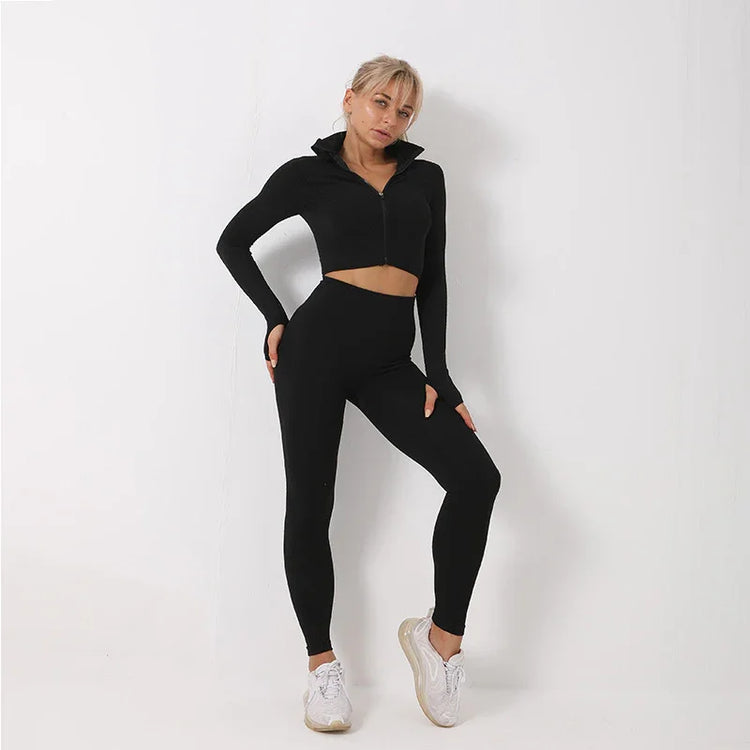 Woman wearing black long-sleeve zip-up crop top and high-waisted fitted leggings