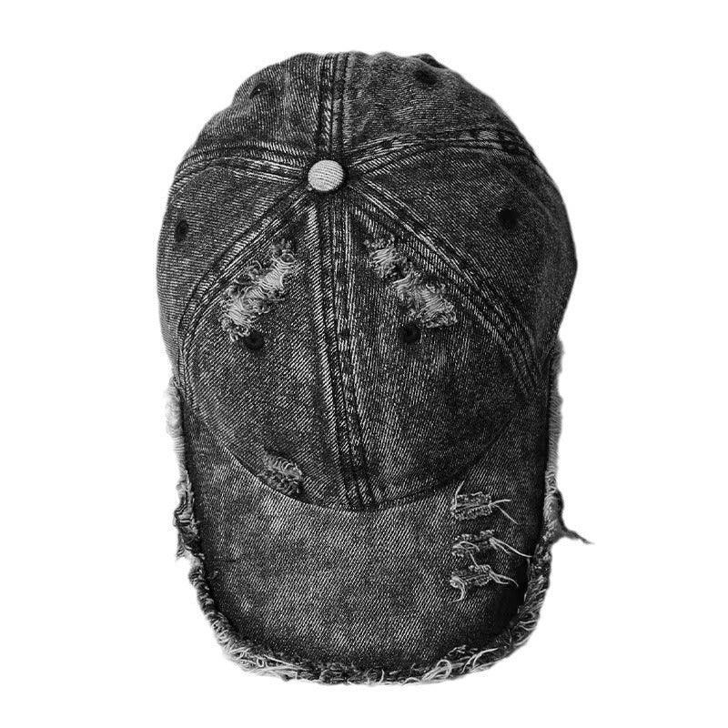 Black distressed denim cap with frayed edges and worn details, streetwear style