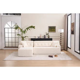 Modern living room with a cream tufted sofa, plush upholstery, and relaxed fit