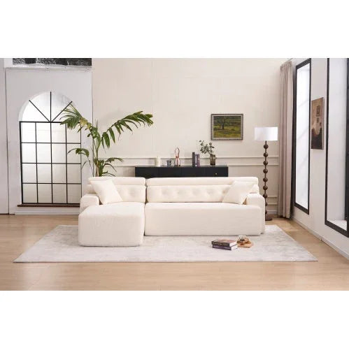 Modern living room with a cream tufted sofa, plush upholstery, and relaxed fit