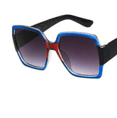 Square oversized sunglasses with blue and red acetate frame, black arms, and gradient lenses.