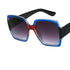 Square oversized sunglasses with blue and red acetate frame, black arms, and gradient lenses.