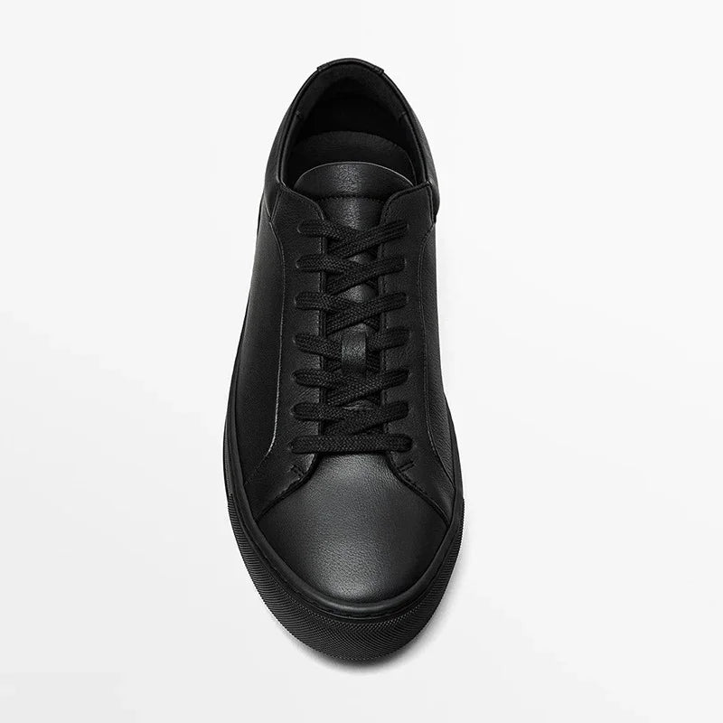 Minimalist black leather sneaker with lace-up design and low-top fit on white background