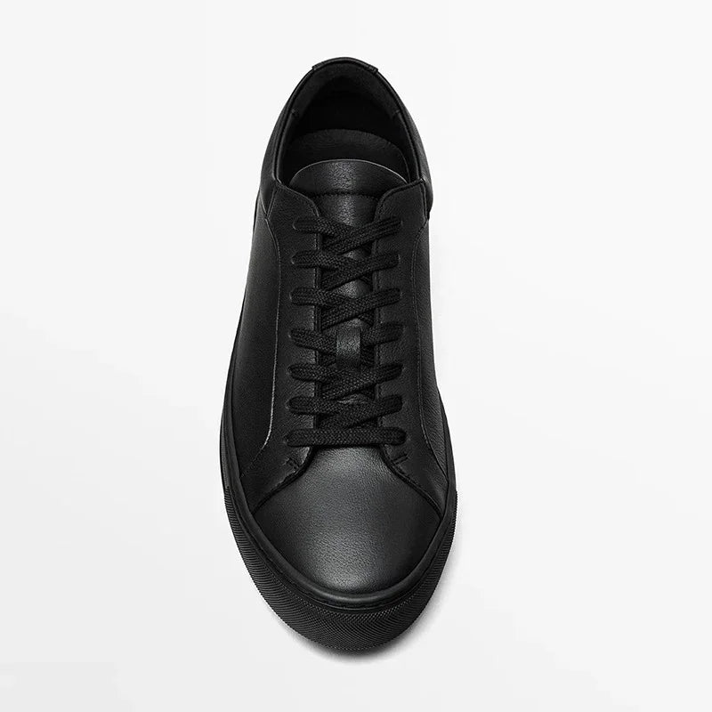 Minimalist black leather sneaker with lace-up design and low-top fit on white background