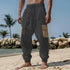 Man wearing loose fit black cargo joggers with beige pockets on a beach