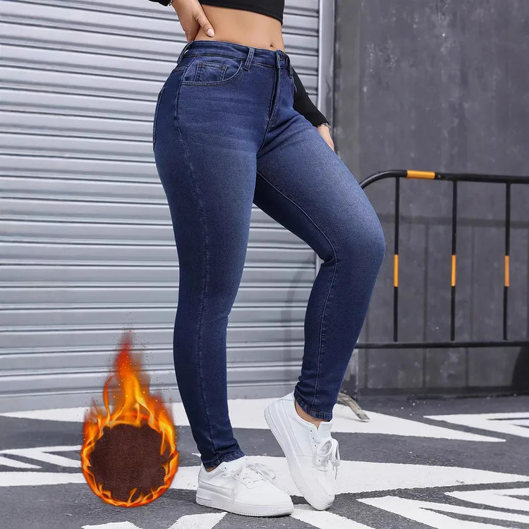 Woman wearing high-waisted dark blue skinny jeans, fleece-lined, urban street style