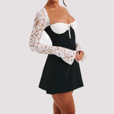 Black mini dress with white lace long sleeves and bust, fitted and flared style