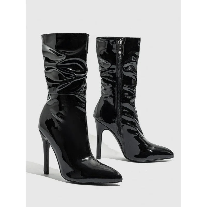 Shiny black patent leather ankle boots with pointed toe and high stiletto heel