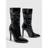 Shiny black patent leather ankle boots with pointed toe and high stiletto heel