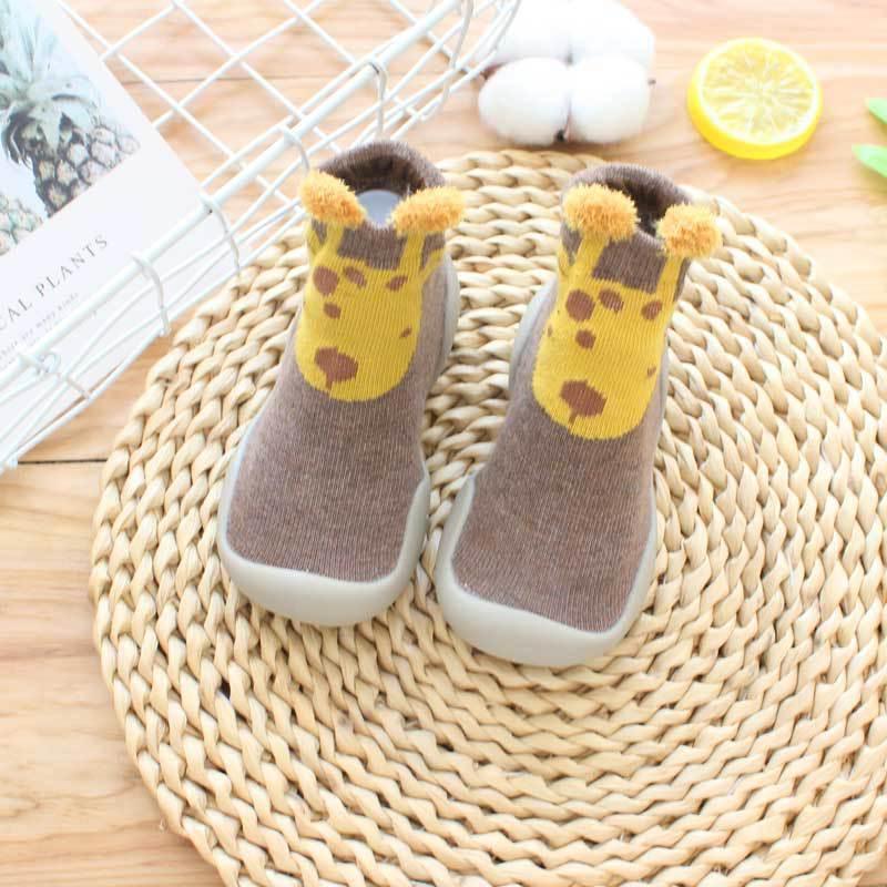 Brown knit toddler sock shoes with yellow giraffe design and flexible rubber soles