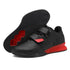Black and red athletic sneakers with velcro straps, mesh upper, and textured outsole