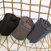 Neutral toned rolled streetwear leggings on wire chair, soft stretch fabric, slim fit