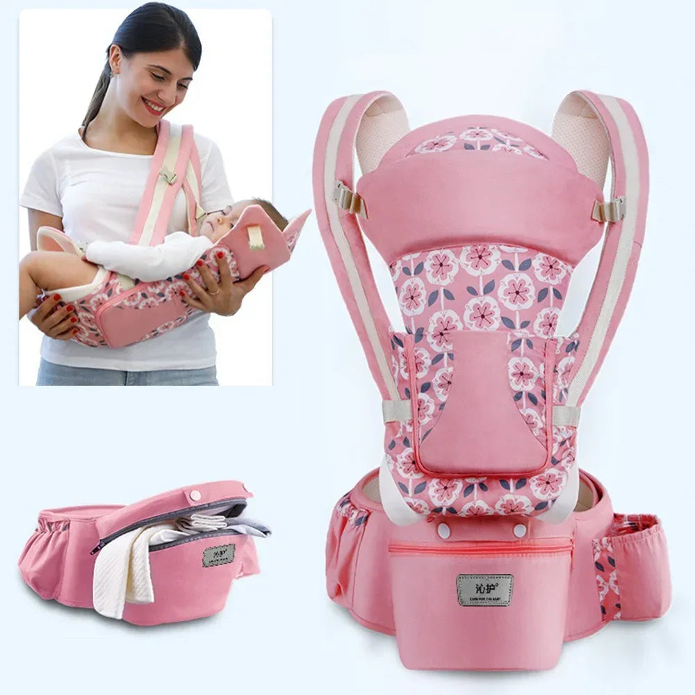 Pink floral baby carrier with adjustable straps and storage pockets, soft cotton material, ergonomic fit.