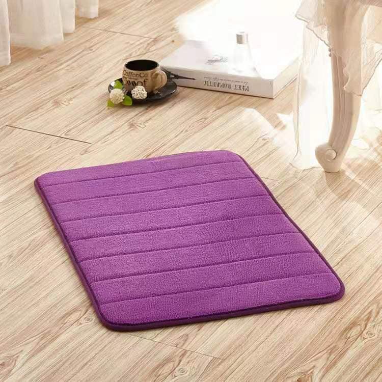 Purple rectangular floor mat with soft microfiber texture on light wood flooring
