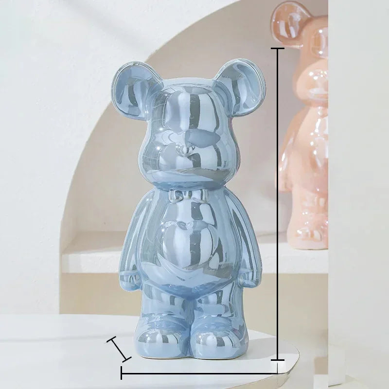 Glossy blue bear-shaped ceramic figurine with reflective surface, modern decor setting.