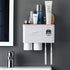 Wall-mounted white plastic bathroom organizer with cups and compartments, holding toiletries and toothbrushes