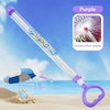 Purple water gun with clear barrel and spray nozzle, beach background, summer fun toy