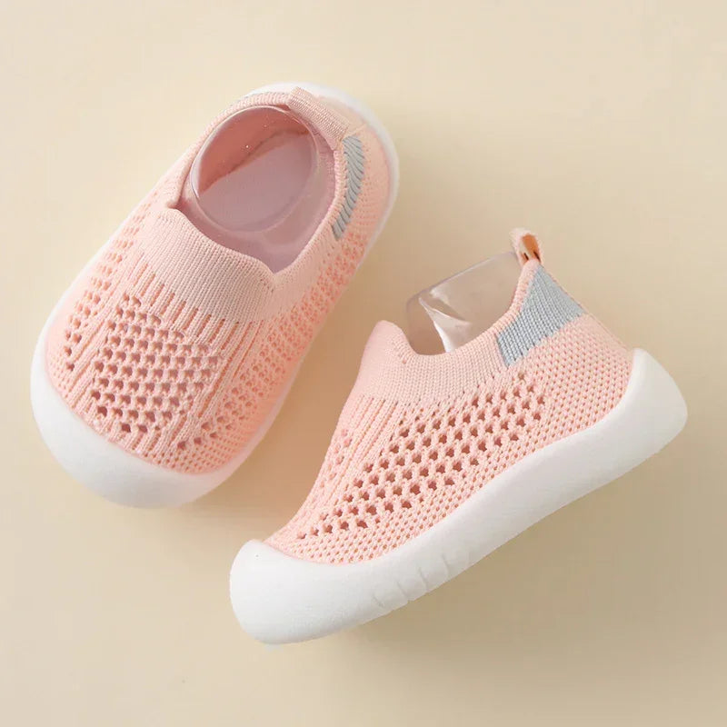 Pink slip-on knit baby shoes with breathable mesh and white rubber soles