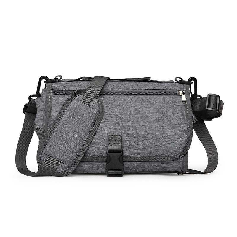 Modern grey messenger bag with adjustable strap, front buckle closure, and zippered pocket
