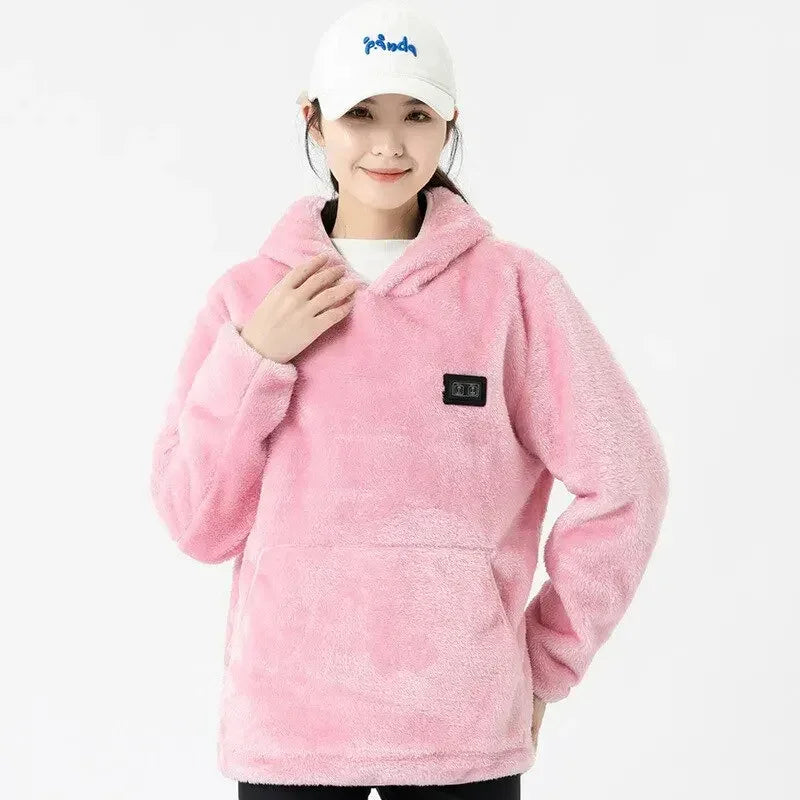 Woman wearing a loose fit pink fleece hoodie with long sleeves and front pocket, cozy streetwear style.