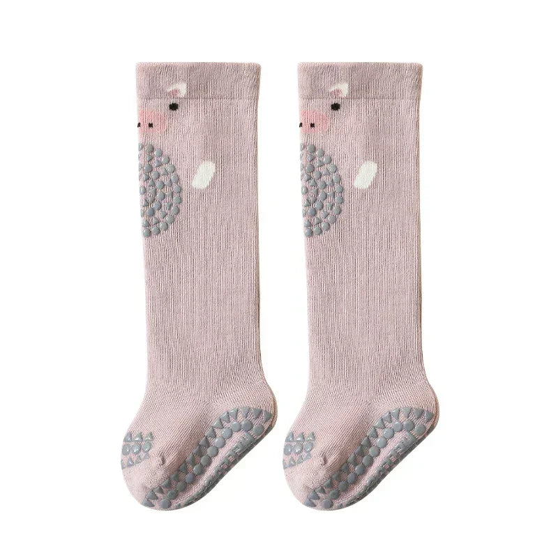 Cute light pink knee-high socks with animal face design, non-slip grip soles, soft knit material