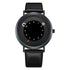 Modern black minimalist wristwatch with leather strap and unique circular dial design