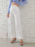 Woman wearing high-waisted white straight-leg jeans and black heeled sandals