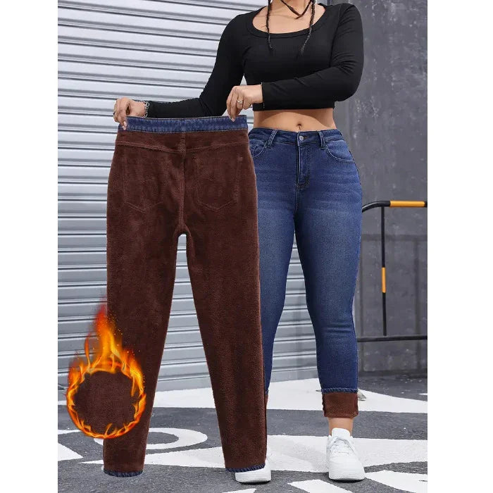 Woman wearing blue fleece-lined skinny jeans and holding brown fleece pants, with warm thermal fabric shown.