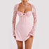 Light pink mini dress with lace long sleeves, fitted silhouette, and front tie detail