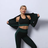 Woman in black and dark green textured seamless sports bra and high-waisted leggings, fitted style