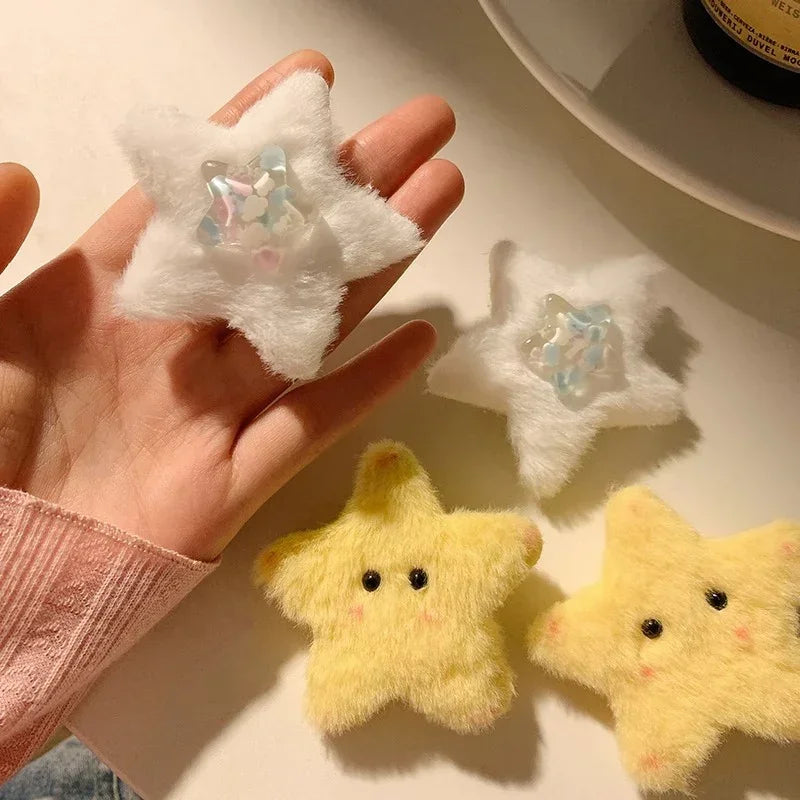 Soft plush star-shaped hair clips in white and yellow with cute eyes, fluffy texture