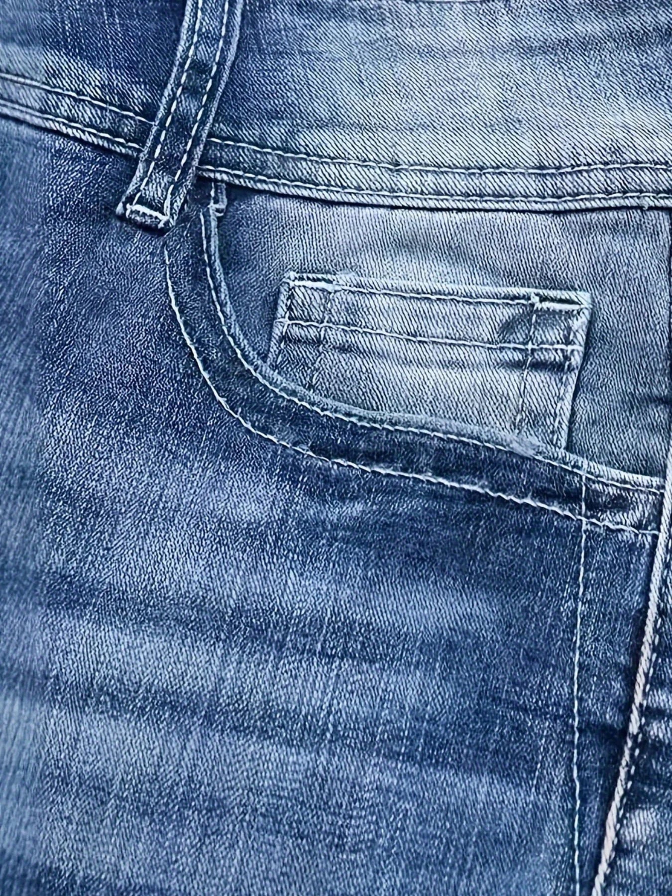 Close-up of blue denim jeans pocket, stonewashed cotton fabric, classic fit.