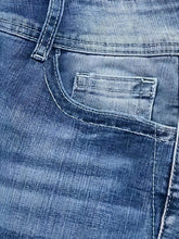 Close-up of blue denim jeans pocket, stonewashed cotton fabric, classic fit.