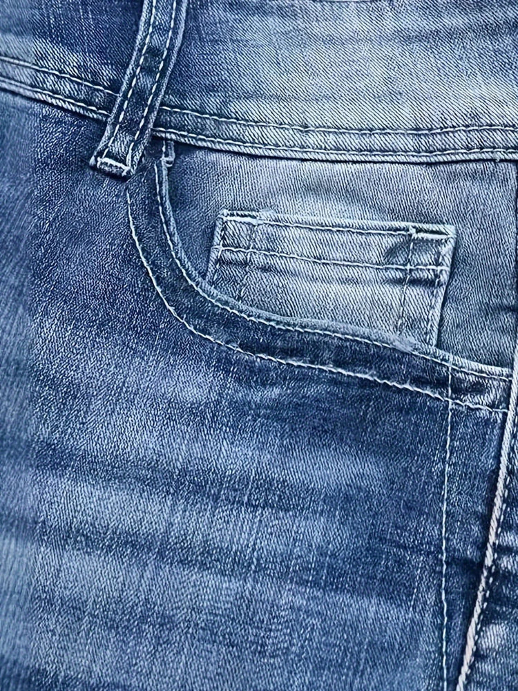 Close-up of blue denim jeans pocket, stonewashed cotton fabric, classic fit.