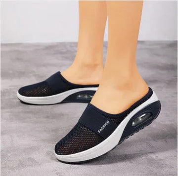 Black mesh slip-on sneakers with white thick sole and visible air cushion, breathable casual fit