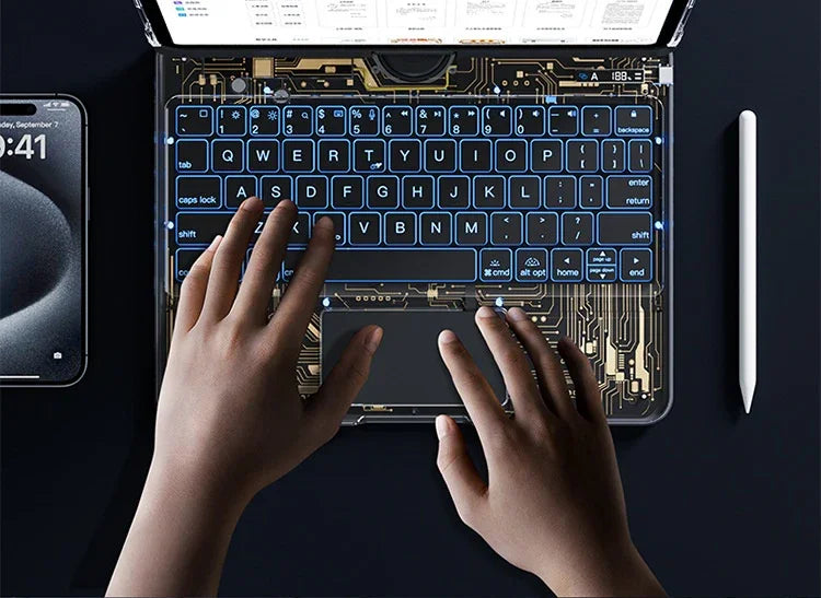 Hands typing on a tech-inspired, transparent backlit keyboard with circuit design