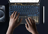 Hands typing on a tech-inspired, transparent backlit keyboard with circuit design