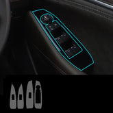 Black car door panel with illuminated blue outline, featuring power window control buttons and a side mirror adjustment knob.