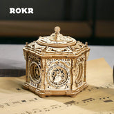 Intricately detailed wooden music box with ornate laser-cut design on tabletop