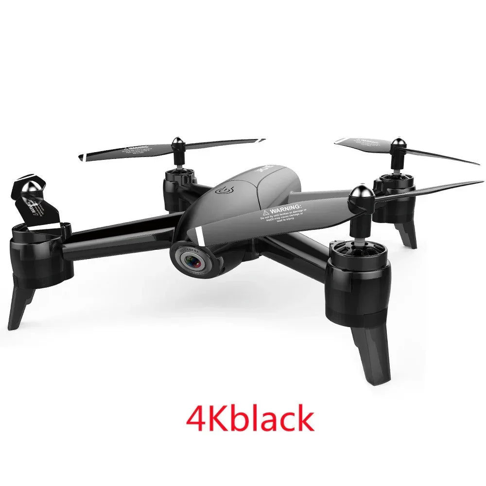 Black 4K camera drone with sleek aerodynamic design and foldable propellers on white background.
