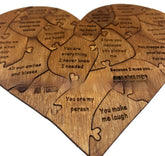 Heart-shaped wooden puzzle with engraved romantic messages on each piece, rustic style.