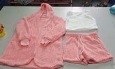 Pink sherpa hoodie, matching drawstring shorts, and a white fuzzy tank top set on table