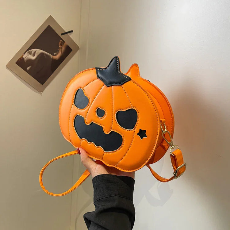 Orange pumpkin-shaped crossbody bag with black face, faux leather, playful streetwear accessory