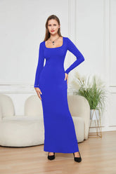 Woman wearing a fitted royal blue long-sleeve maxi dress with square neckline