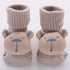 Beige knit baby socks with bear face design, ribbed cuffs, soft cotton material, cozy fit