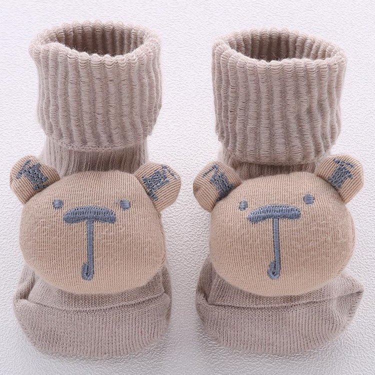 Beige knit baby socks with bear face design, ribbed cuffs, soft cotton material, cozy fit